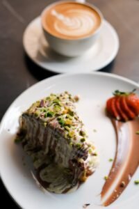 delicious chocolate cake with latte in cafe setting