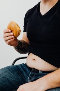 person in black shirt holding a burger